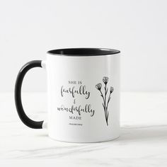 two black and white coffee mugs with the words, she is absolutely wonderfully made