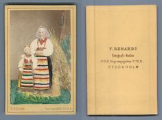 an old book with two pictures of women in colorful clothing and one is holding a baby