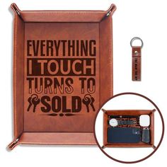 there is a leather case with a keychain and cell phone in it that says everything i touch turns to sold