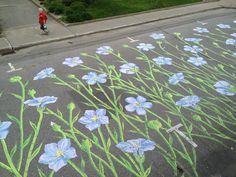 a person is walking on the sidewalk with flowers painted on it