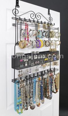 a wall mounted jewelry rack on the side of a door