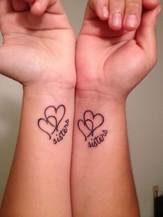 two people holding hands with tattoos on their arms and the words news feed written on them