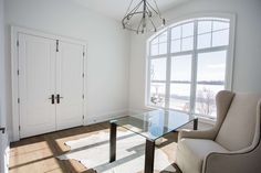 a living room with a glass table and two chairs