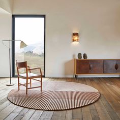 a living room with wooden floors and white walls