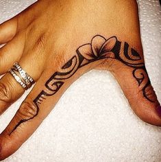 a woman's hand with a tattoo on it