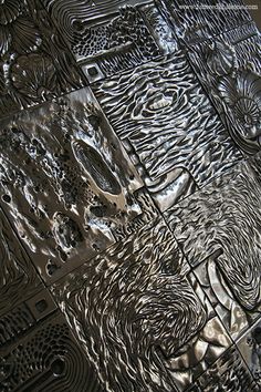 an intricately designed metal surface is shown