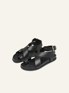 The Jalen Sandal sits atop a molded footbed, featuring a toe hold and two criss-cross straps that encase the foot and finish with a soft gold buckle around the ankle. This style is made from full grain leather with leather upper, insole and rubber outsole. Full leather sandals are premium in their make and wear naturally over time.[tab] Composition: 100% Leather upper & insole. 100% Rubber outsole. Size and Fit: Runs True to Size Origin: Imported SKU: AEM48P306-BLK Questions about size, fit, or Birthday Discount, Footbed Sandals, Closet Staples, Crazy Shoes, Summer 2023, Cross Straps, Full Grain Leather