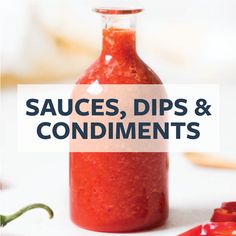 a bottle filled with sauces, dips and condiments on top of a table