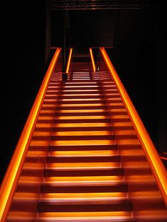 the stairs are lit up with orange lights