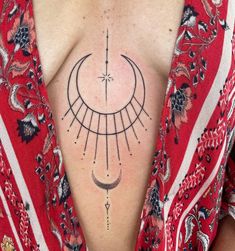 a woman's chest with a sun and moon tattoo on her left side ribcage