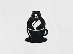 a bear sitting in a coffee cup