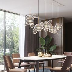 a dining room table with chairs and lights hanging from it's centerpieces