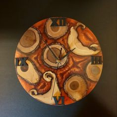 a clock made out of wood with different designs on the face and numbers painted on it