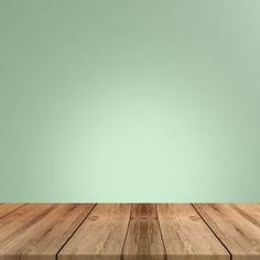 an empty wooden table in front of a green wall with copy - space for your text