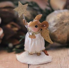 a figurine of a mouse holding a star