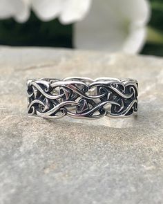 a silver ring sitting on top of a rock