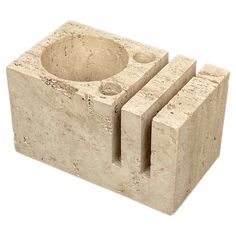 a stone block with two holes in the middle and one hole at the top, on a white background