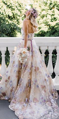 a woman in a wedding dress standing on a balcony