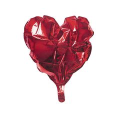 a heart shaped lollipop is being held up by someone's hand,