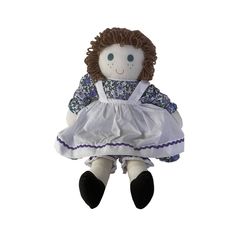 a stuffed doll wearing a white dress and black shoes is sitting on a white background