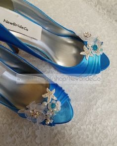 two pairs of blue shoes with flowers on the toes and one has a name tag that says new bride