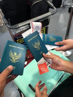 two people exchanging passports at an airport