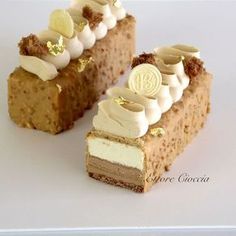 a piece of cake with white frosting and gold decorations on the top is cut in half