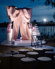 a stage set up for an event with candles and flowers