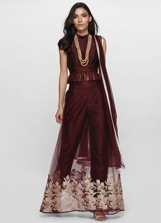 Get a unique style for yourself this season. Adorn this stunning wine net zari embroidered skirt with dupion pants lining. This skirt comes with a wine dupion sleeveless crop top which has band collar and net frill detailing at the hem. Pant Lehenga, Wine Pants, Embroidered Skirt, Sleeveless Crop Top, Ethnic Wear