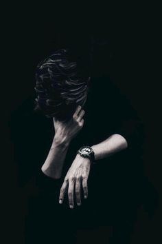 black and white photograph of a woman's hand resting her face on her arm