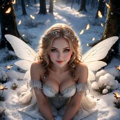 a woman dressed as a fairy sitting in the snow