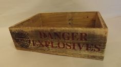 an old wooden box with the word danger explosives written on it's bottom and inside