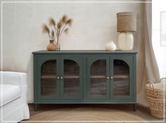 a green cabinet with glass doors in a living room next to a white couch and wicker basket