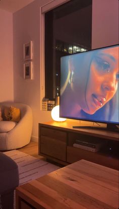 a flat screen tv sitting on top of a wooden table