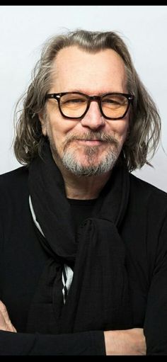 a man wearing glasses and a black scarf