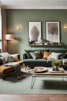 a living room with green walls and two pictures on the wall above the couches