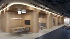 an empty conference room with wooden walls and ceiling lights on either side of the table