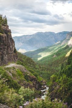 there is a mountain view from the top of a hill with a river running through it