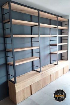 an empty room with shelves and cabinets in the middle, one wall is painted blue