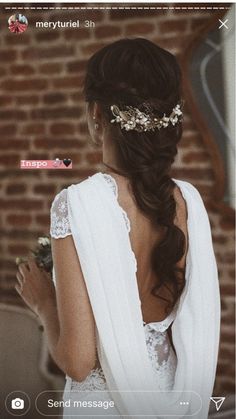 the back of a woman wearing a white dress and holding a flower in her hand