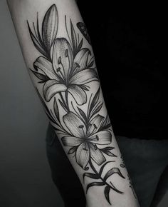 a black and white flower tattoo on the arm