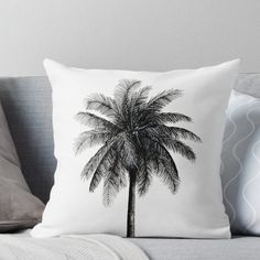 a black and white photo of a palm tree on a couch with the back turned down