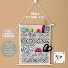 the wall organizer has five pockets to hold pens, pencils and scissors in it