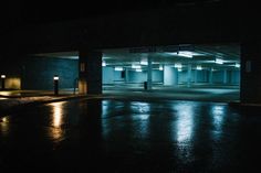 an empty parking garage at night with lights on