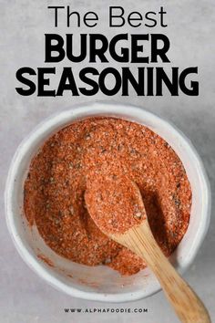 the best burger seasoning recipe in a white bowl with a wooden spoon on top