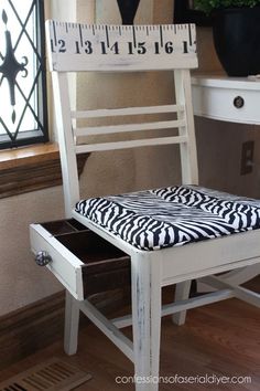 a white chair with a zebra print seat pad on top of it next to a window