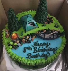 a birthday cake in the shape of a camper's tent