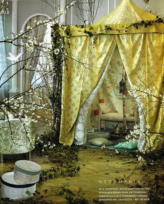 an image of a room that is decorated in white and yellow with flowers on the walls