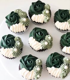 six cupcakes with green frosting and white icing are arranged on a plate