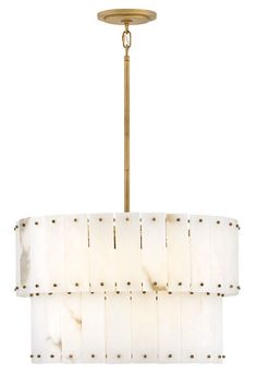 a chandelier with white fabric shades hanging from a brass ceiling fixture on a white background